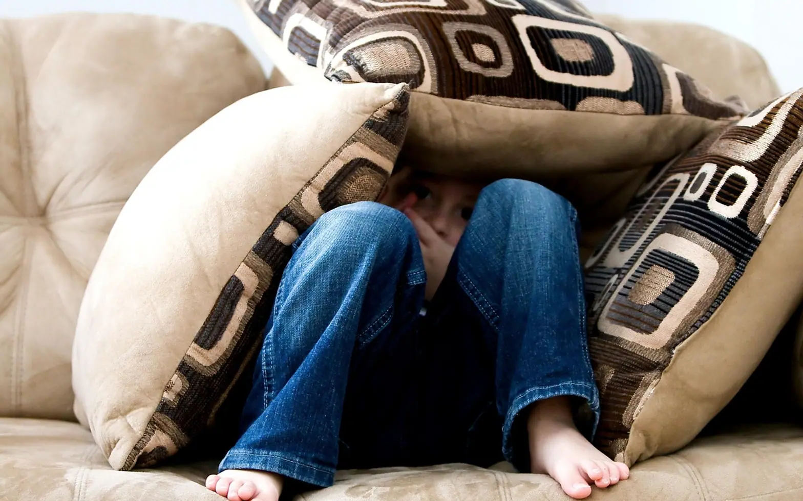 Little boy, hiding and sad