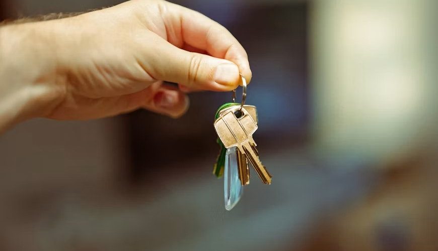 A hand holding keys to a home